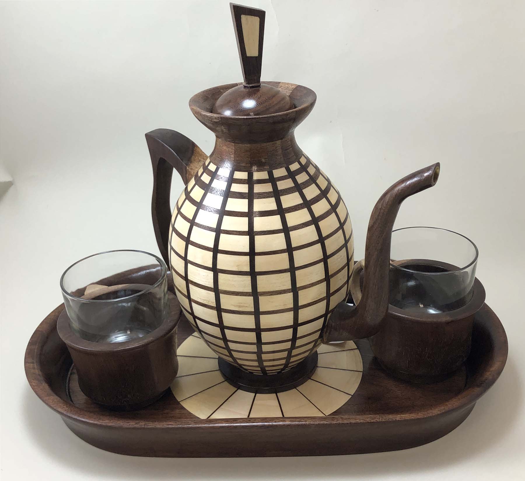 Woodturned teapot displayed with other turned pieces